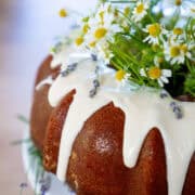 Vanilla Bundt Cake with vanilla glaze and delicate white and yellow flowers